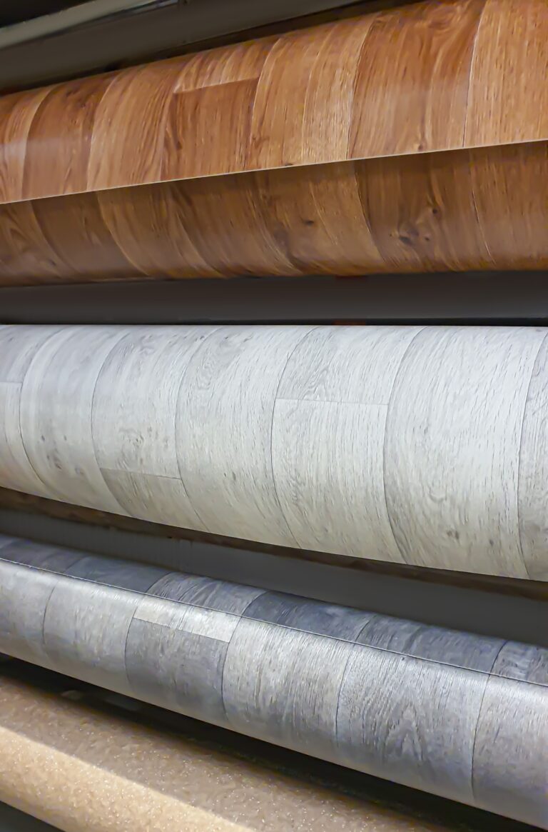 The store sells multi-colored laminate flooring. Repair and construction, large rolls